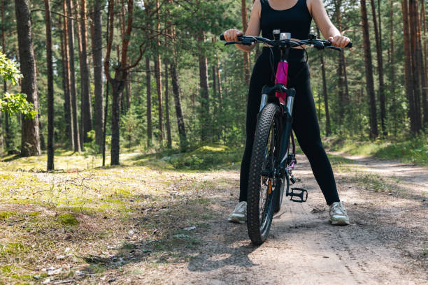 istock Bicycle parked on a forest trail, suggesting a perfect setting for mountain biking. The trail winds through dense trees, providing a scenic and adventurous backdrop. 2179613674