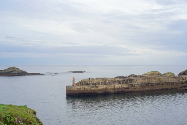 istock Distant fisherman in a concrete pier 2179617329