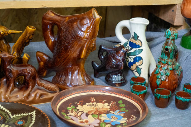 Decanter fish shape and figurines. Ukrainian dishes. Clay ceramics food plate decor painting. Set different crockery tableware in kitchen