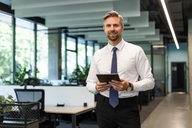 istock Handsome businessman using his tablet in the office 2179621181