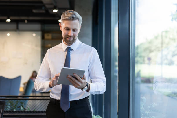 istock Businessman with tablet in office for schedule, email and financial administration 2179622527