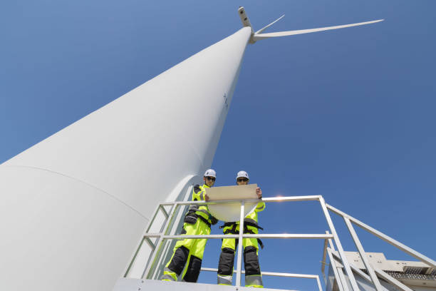 istock Engineers are having a discussion at wind turbine field 2179624869