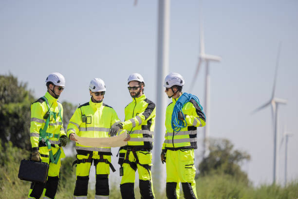 istock Engineers are having a discussion at wind turbine field 2179624874