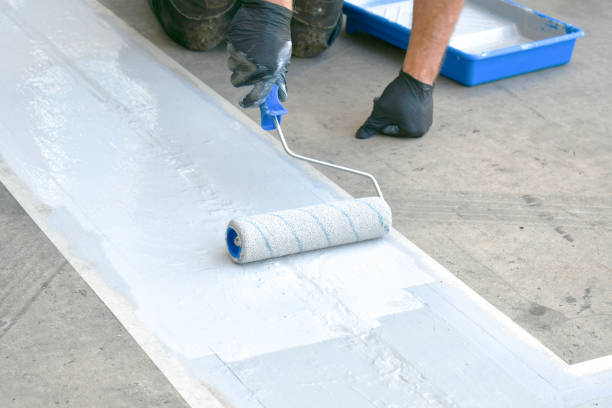 istock Man painting a line on concrete. 2179634084