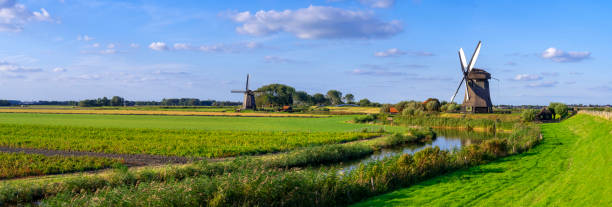 istock Dutch Windmills along a Canal near Schermerhorn, Netherlands 2179635111