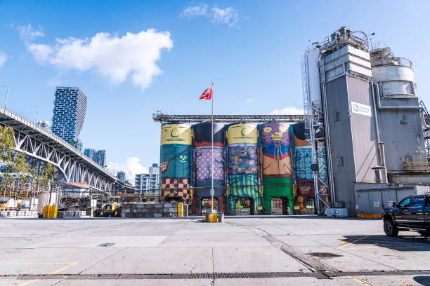 Giants Mural on Granville Island Vancouver, British Columbia, Canada September 27, 2024: A mural titled Giants was spray painted on six concrete silos and can be seen on Granville Island in Vancouver, BC, Canada. The mural was created for the Vancouver Biennale and is now a major attraction. granville island stock pictures, royalty-free photos & images