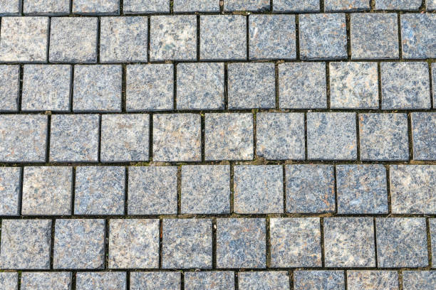 istock Stone block pavement in the rays of the setting sun. Texture 2179640439