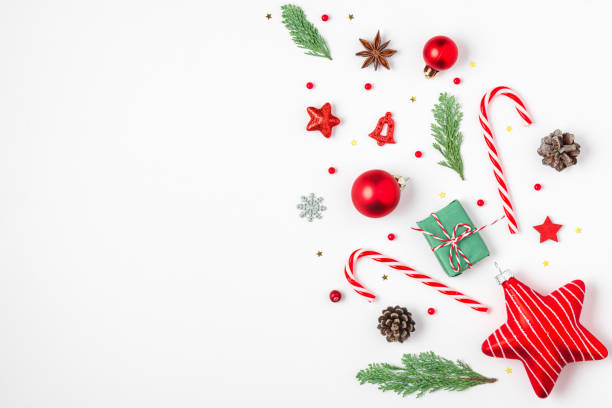 istock Christmas background with fir branches, gift boxes, red decorations, candy and pine cones isolated on white background. Flat lay. Happy New Year and winter holidays background. Top view 2179642291