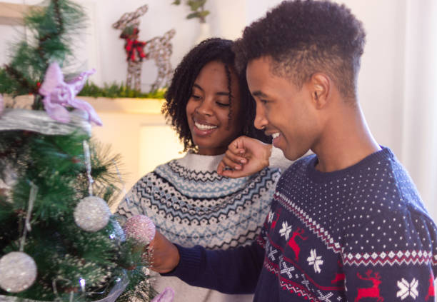 istock Happy couple decorating christmas tree at home 2179644511