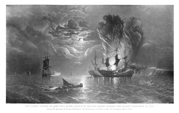 US Navy ship Bonhomme Richard Defeats British Royal Navy Ship Serapis, September 23, 1779, 18th Century World History U.S. ship Bonhomme Richard, commanded by John Paul Jones, wins against the British Royal Navy ship Serapis off coast of England. Painting, by Thomas Mitchell. Engraving published 1898. Copyright expired; artwork is in Public Domain. john paul jones stock illustrations