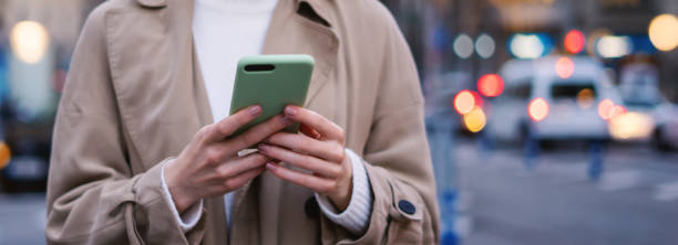 istock Young woman with smartphone in her hands 2179646239