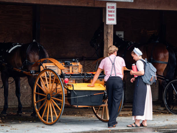 Amish couple in Lancaster, PA Lancaster, PA, USA July 15, 2023: A young Amish couple getting ready to go on a buggy ride Amish stock pictures, royalty-free photos & images