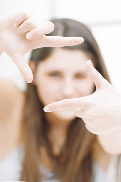 istock Young woman framing her face with fingers 2179652320