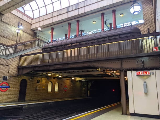 London, UK - 2021.10.15: Two empty Gloucester Road Station platforms of District Line and Circle Line with overlooking balcony from ticket hall under arched skylights with sunlight coming in