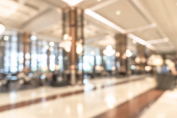 istock Blurred hotel or office building lobby blur background interior view with reception hall lounge, modern luxury white room space with blurry corridor and building glass wall window 2179653589