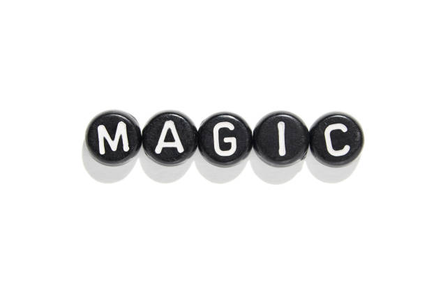 istock Black beads with white letters spelling magic on white background for creative 2179654363