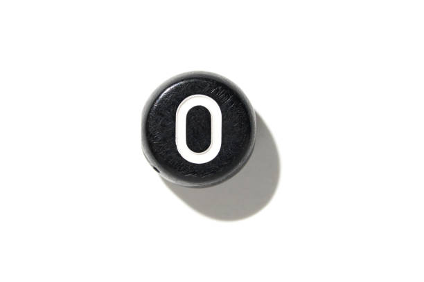 Close-up of black and white power button isolated on white background with shadow detail