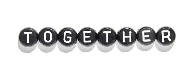 istock Together word formed with black and white letter beads symbolizing unity 2179654372