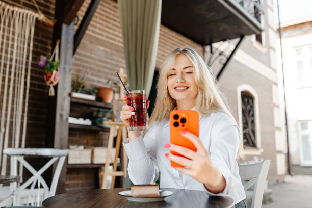 istock young woman sits in cafe 2179654439