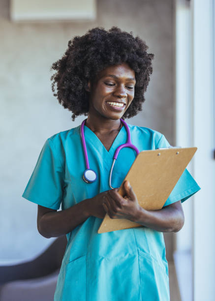 istock Smiling Nurse with Clipboard and Stethoscope in Hospital Setting 2179654615