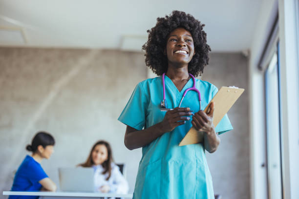 istock Smiling Nurse Holding Clipboard in Hospital Environment 2179654645