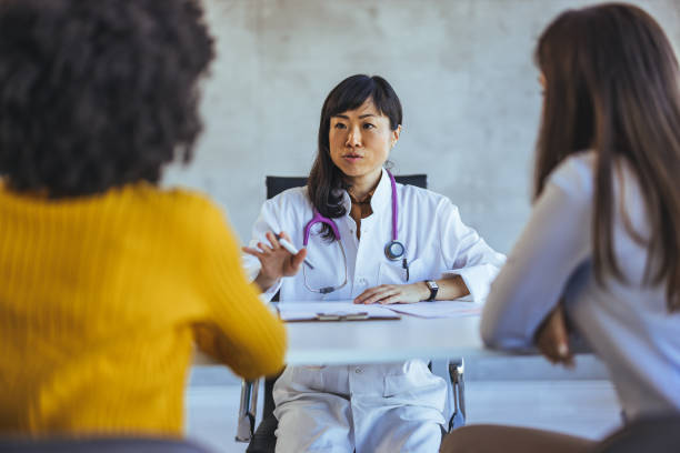 istock Doctor Discussing Health Care Plan with Two Patients at Office 2179654687