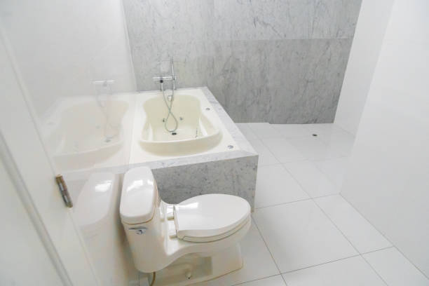 Pure white bathroom interior with separate bathtub