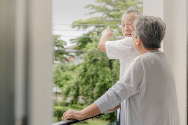 istock Two elderly individuals enjoy a light-hearted conversation and laughter on a balcony, sharing a peaceful and joyful moment in a relaxed outdoor setting, highlighting friendship and companionship. 2179658854