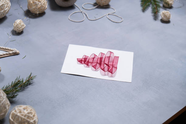 istock Christmas tree ribbon Gift Christmas idea. Do it yourself instruction postcard eco-friendly decoration. Making handmade presents children's diy projects. Holiday family time 2179660389