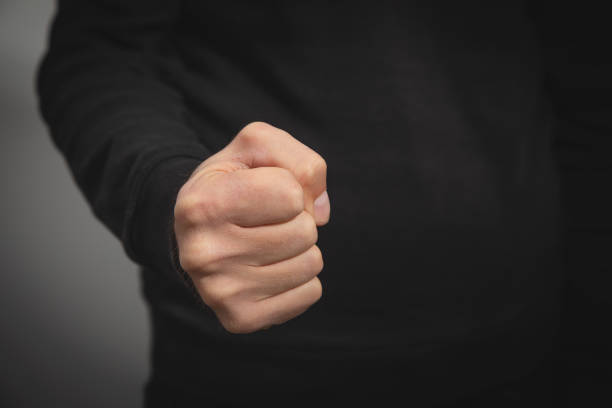 Caucasian angry and aggressive man threatening with fist.