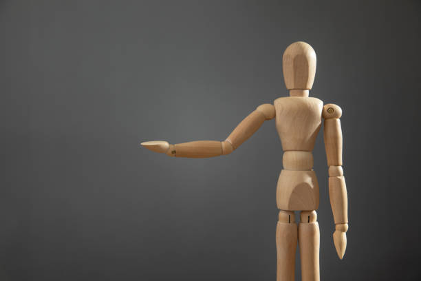 istock Wooden human figure on the grey background. 2179672374