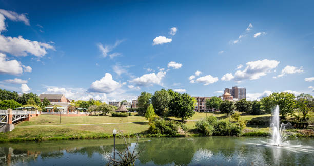 9 Sept. 2024-Maryville, TN: Wide angle skyscape view, from county library, of downtown with foot bridge on left and water feature on right.
