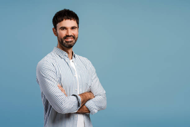 istock Successful bearded man with crossed arms, looking at camera, standing isolated on blue background 2179675906