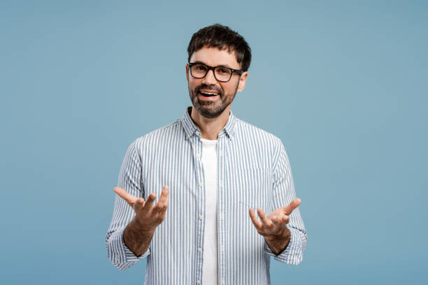 istock Handsome bearded man, wearing stylish eyeglasses gesturing something explaining looking at camera 2179675919
