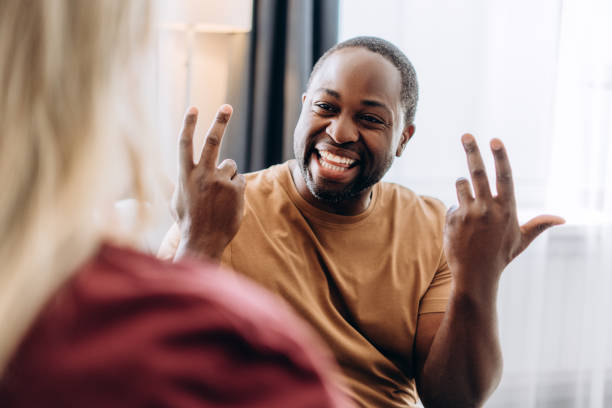 istock Happy young couple communicating through sign language at home 2179680528