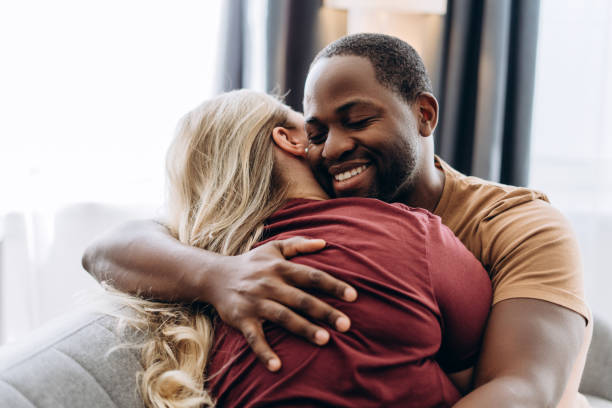 istock Smiling African American man hugging her girlfriend at home 2179680532