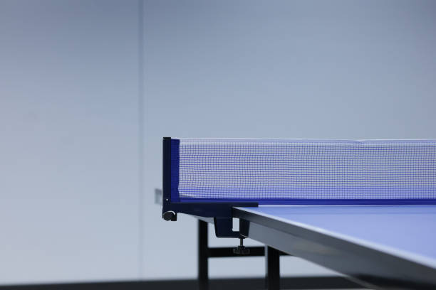 Ping pong table and blue net. Ping pong table with blurred background.