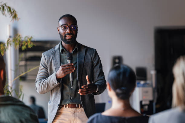 istock Business Professional Delivering Inspiring Conference Speech to Group 2179684389