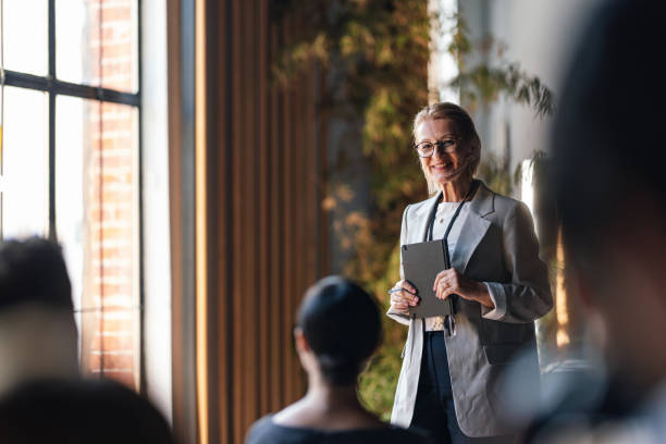 istock Confident Female Speaker Leading a Business Conference 2179684398