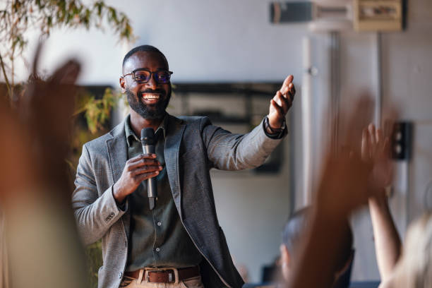 istock Smiling Speaker Engaging with Audience During Business Conference 2179684399