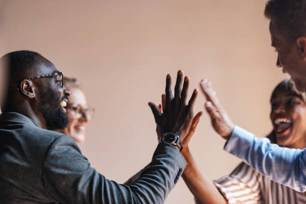 istock Group Of Professionals Celebrating Success With High Five 2179684427