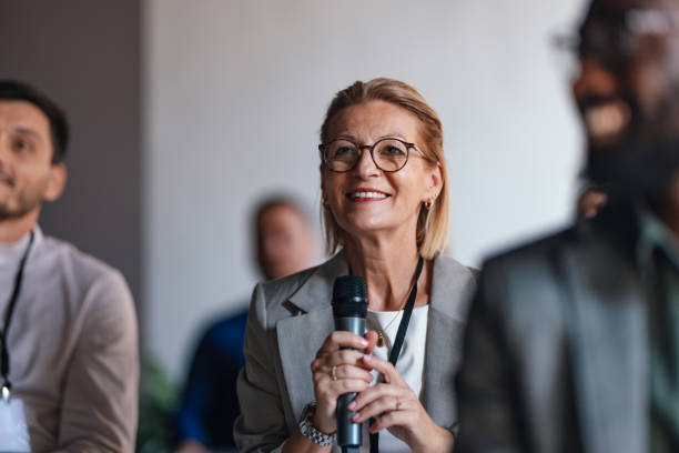 istock Engaged Audience Member Asking Question at Business Conference 2179684439