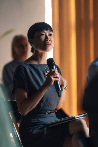 istock Engaged Woman Speaking at a Business Conference Event 2179684445