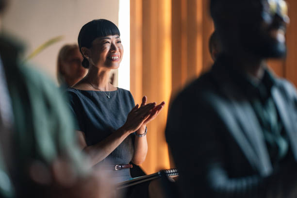 Happy Business Professional Applauding During a Conference Session