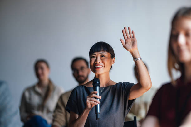istock Enthusiastic Participant Engages in Business Conference Discussion 2179684450