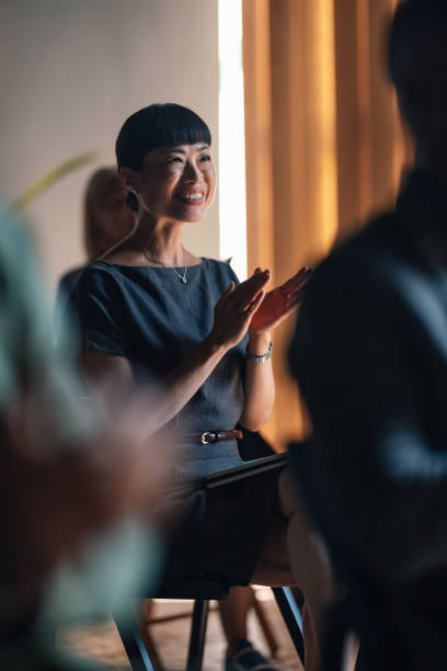 istock Engaged Audience Member Clapping at Business Conference 2179684458