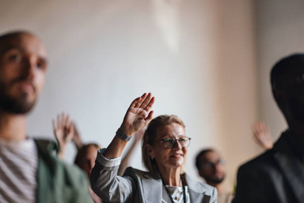 istock Engaged Audience at Business Conference Raising Hands 2179684472