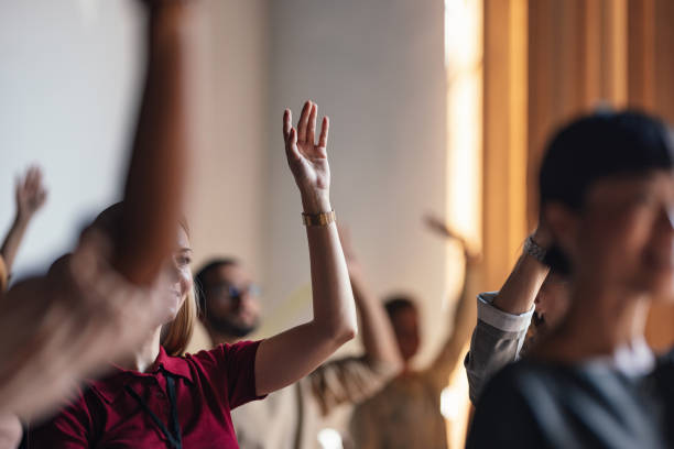 istock Engaged Audience Raising Hands During Business Conference Lecture 2179684475