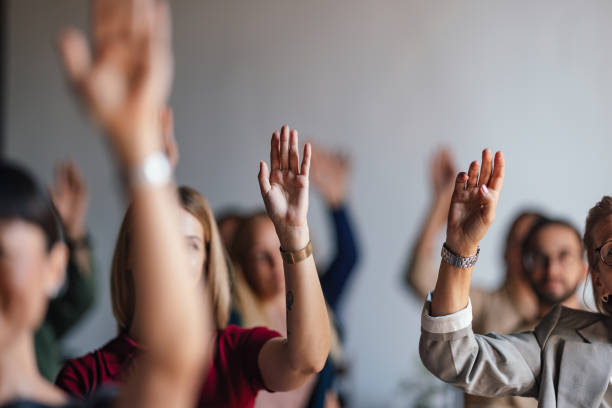 istock Group Participating in Business Conference With Raised Hands 2179684477