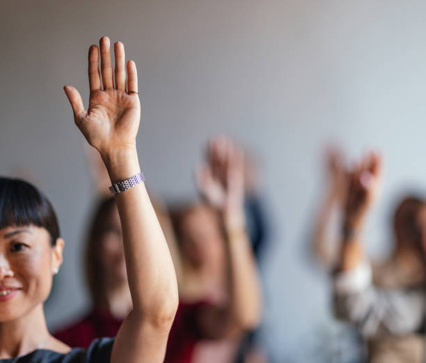 istock Active Participation in Business Seminar with Raised Hands 2179684482